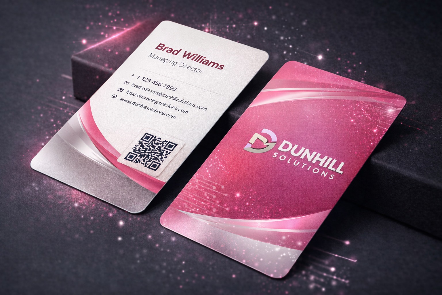 Business card design featuring a pink and silver color scheme for Dunhill Solutions, displaying contact details and a QR code, emphasizing professional branding for business networking.