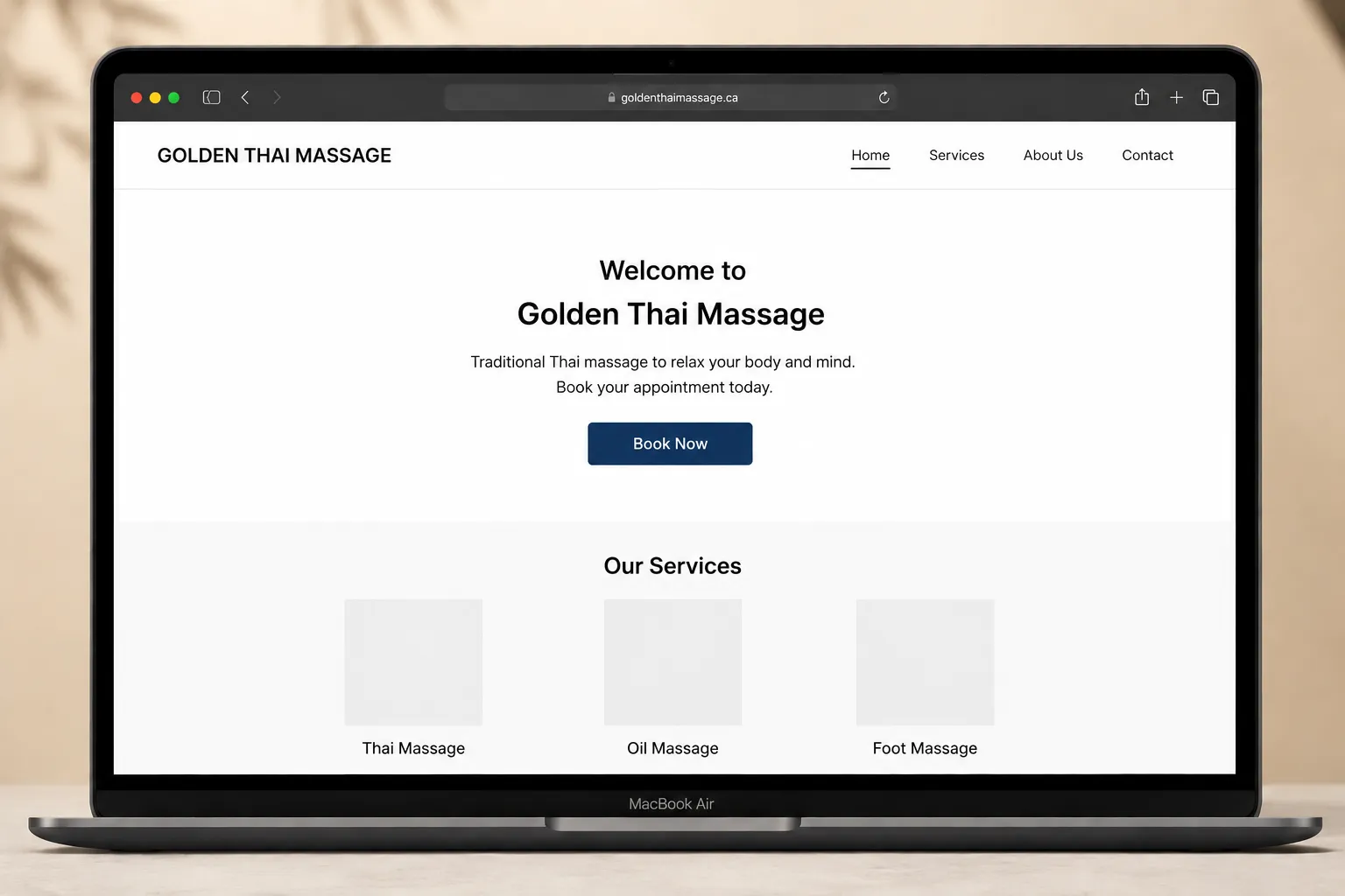 Laptop displaying Golden Thai Massage website homepage and booking interface.